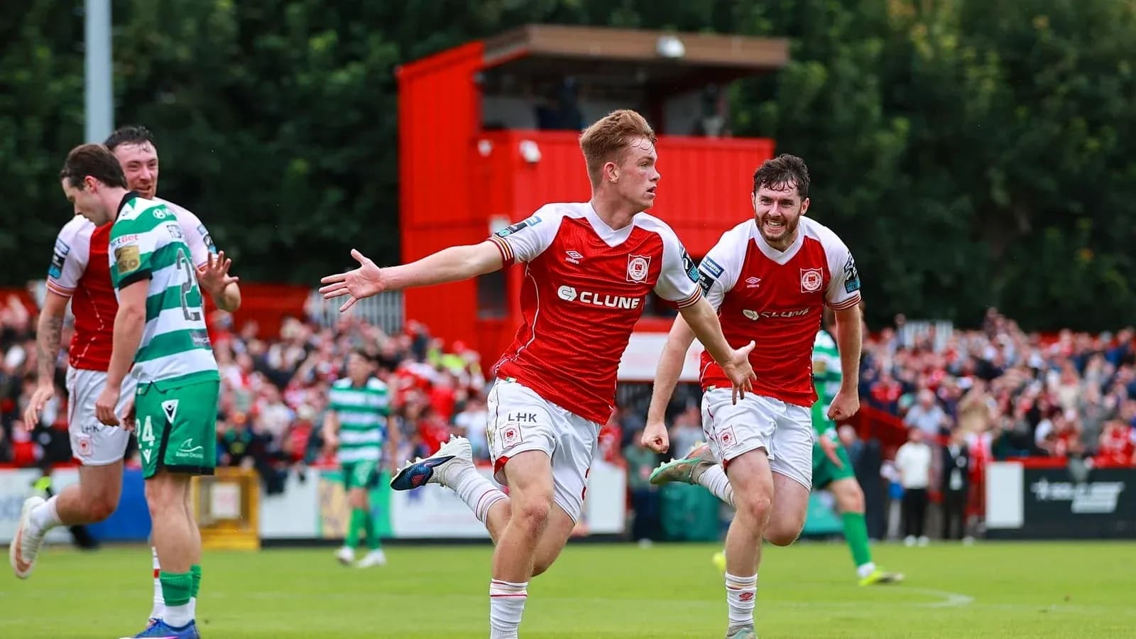 Player celebrating goal with teammates during match Player celebrating goal with teammates during match