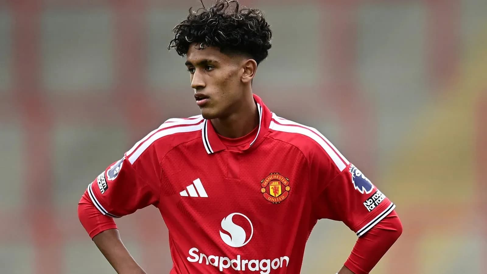 Young player in Manchester United kit during match Young player in Manchester United kit during match