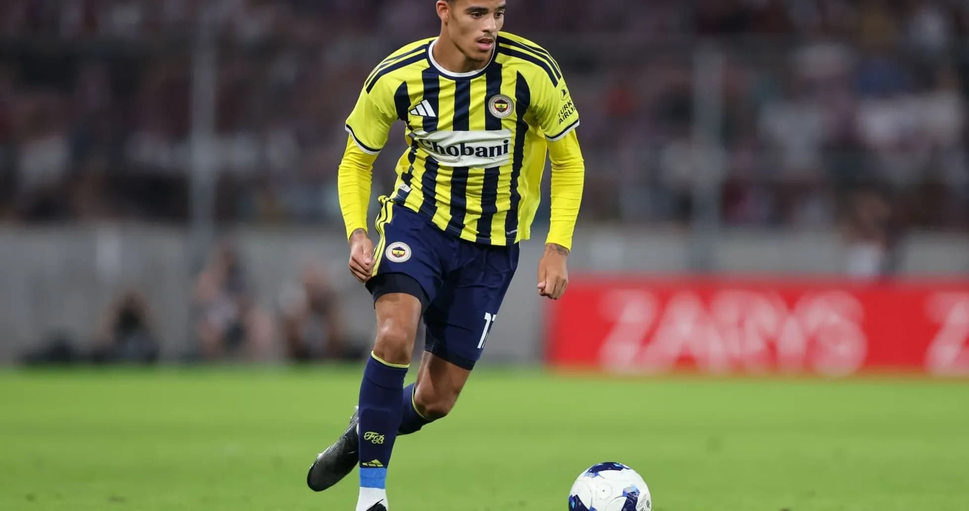 Fenerbahçe player dribbling the ball on field Fenerbahçe player dribbling the ball on field