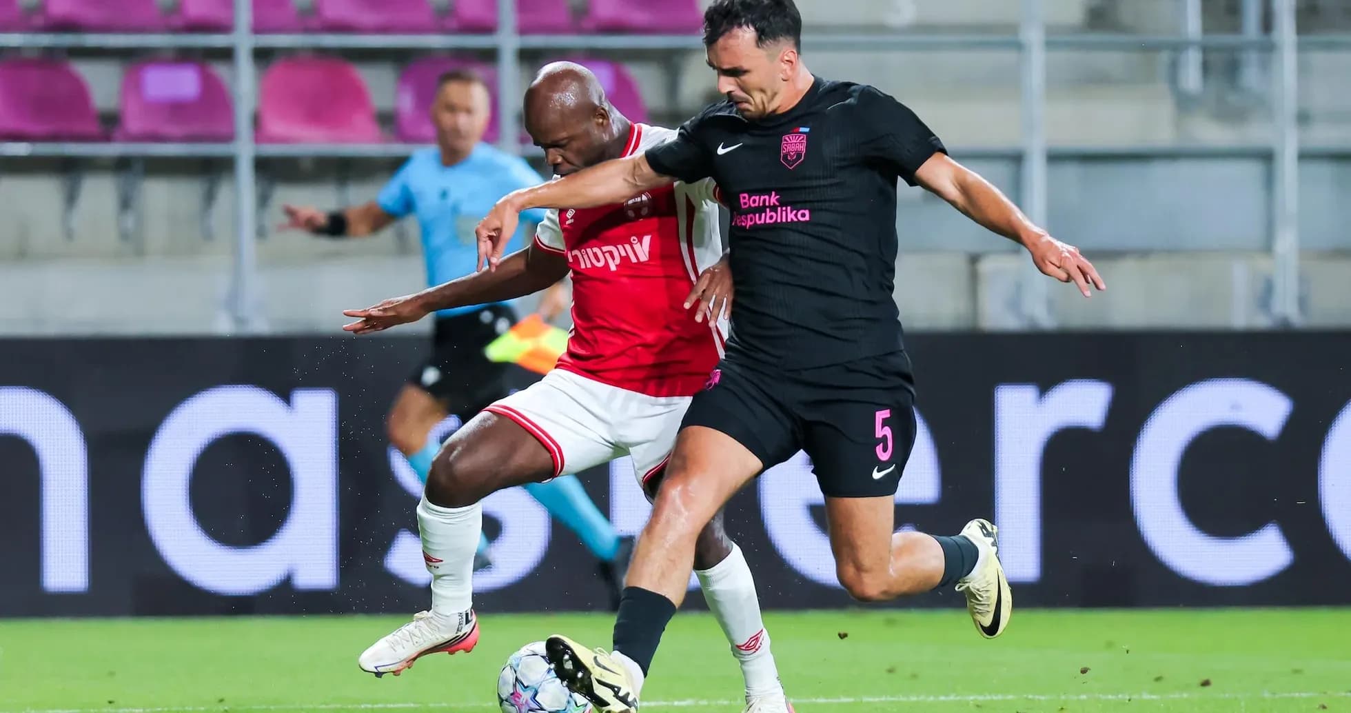 Players competing for the ball during UEFA match Players competing for the ball during UEFA match