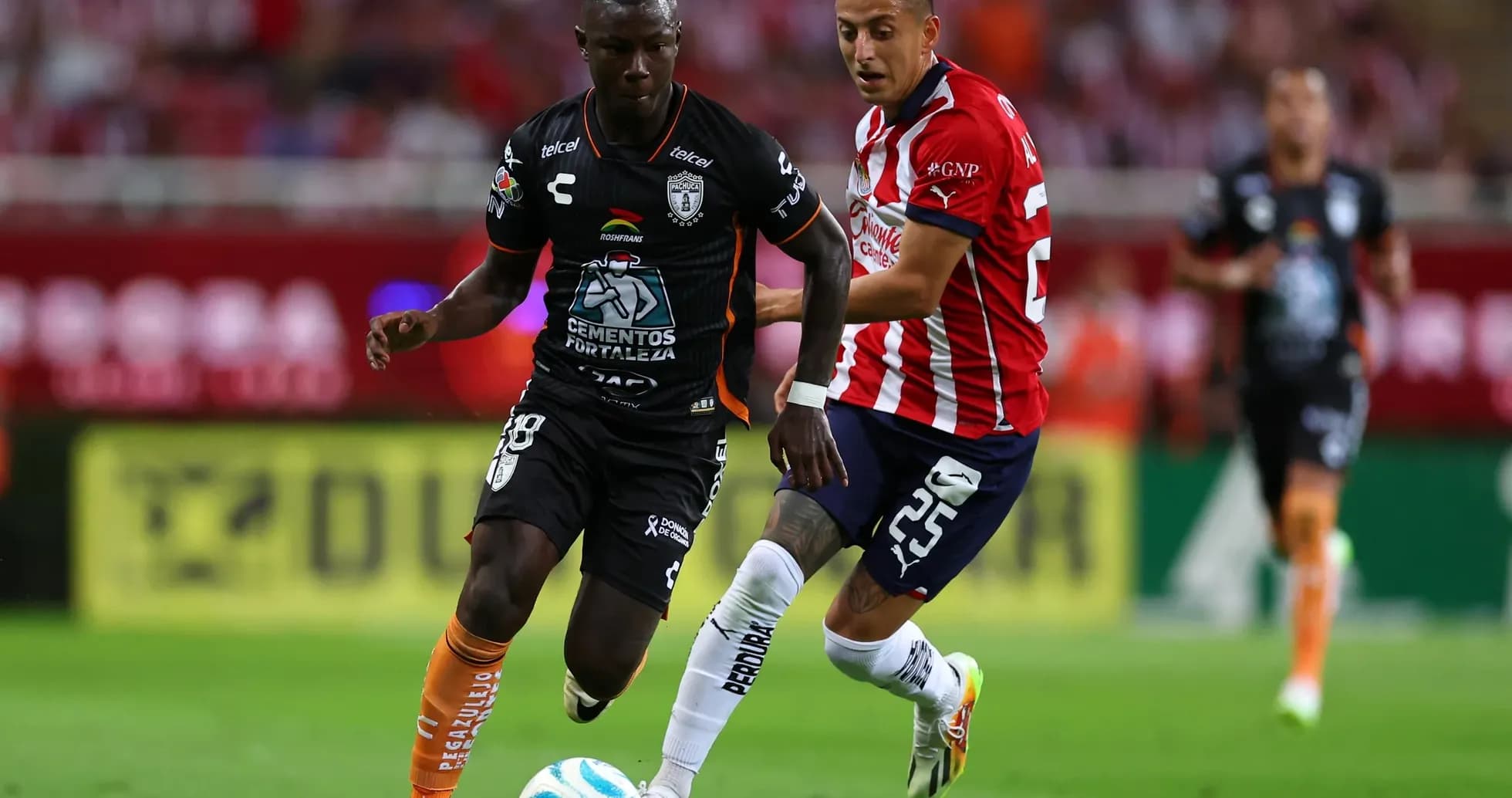 CF Pachuca player competing against Guadalajara Chivas CF Pachuca player competing against Guadalajara Chivas