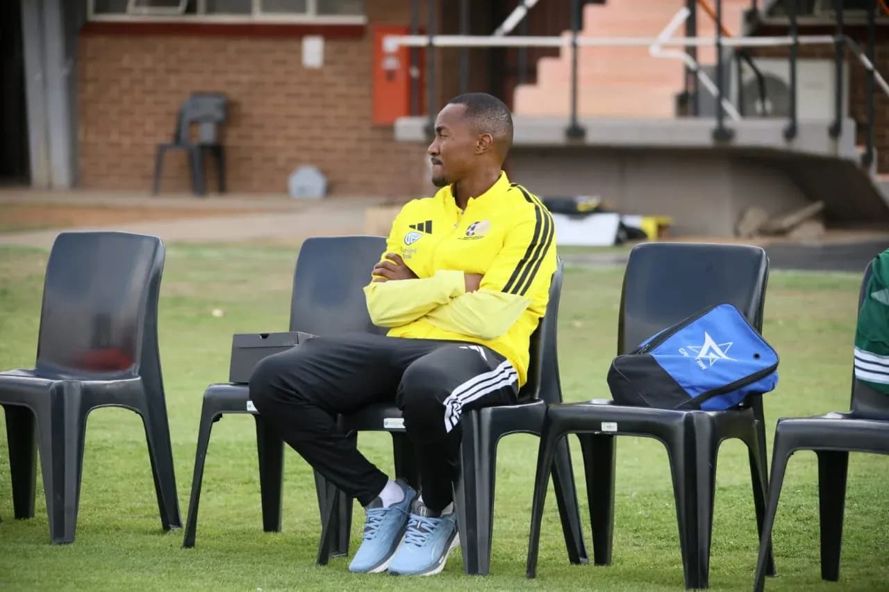 Coach seated on bench during training session Coach seated on bench during training session