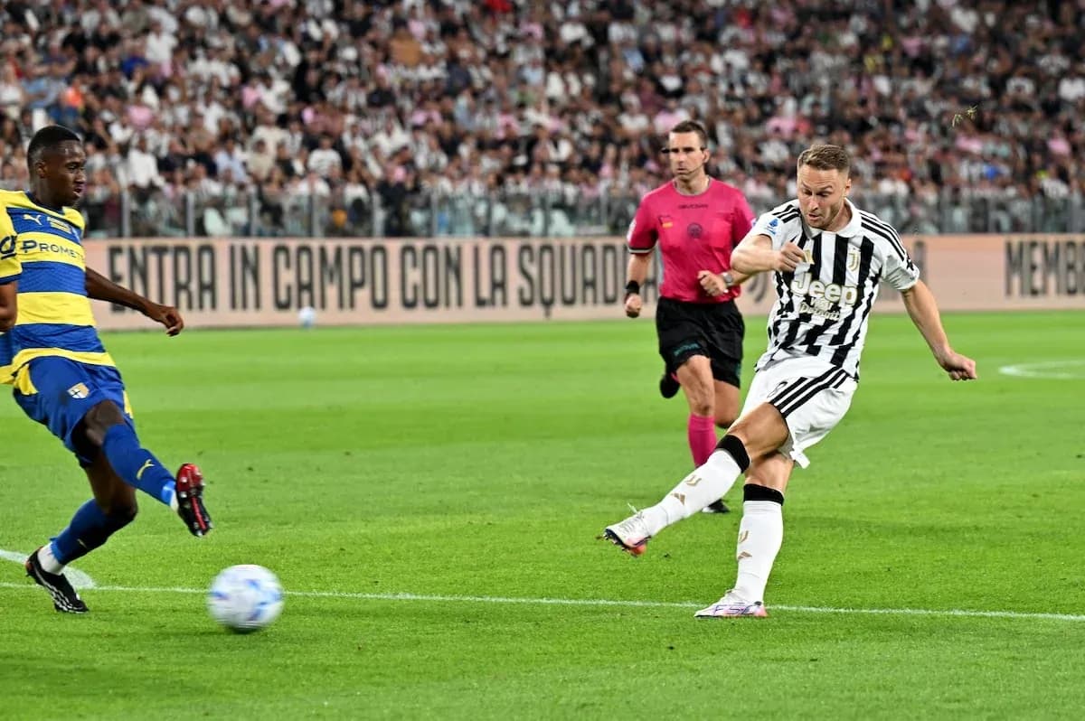 Juventus player shooting during match against Parma Juventus player shooting during match against Parma