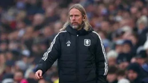 Manager in tracksuit observing match from sidelines Manager in tracksuit observing match from sidelines