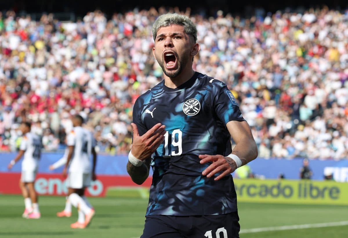 Player celebrating a goal in a packed stadium Player celebrating a goal in a packed stadium