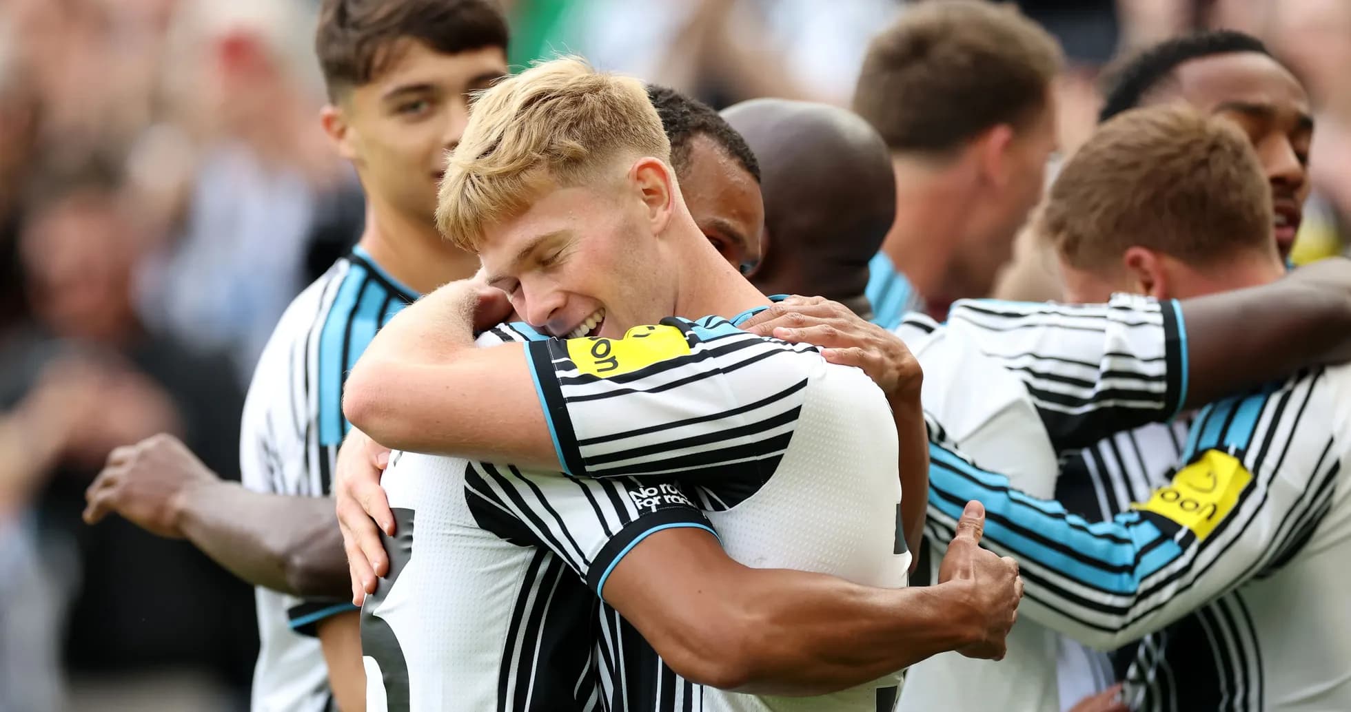 Players celebrating with hugs after scoring a goal Players celebrating with hugs after scoring a goal
