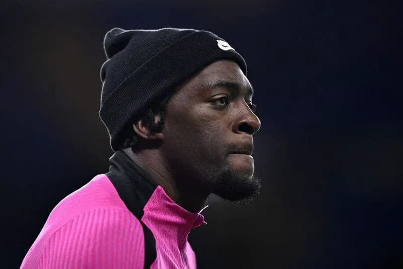 Athlete in pink training gear wearing a black beanie Athlete in pink training gear wearing a black beanie