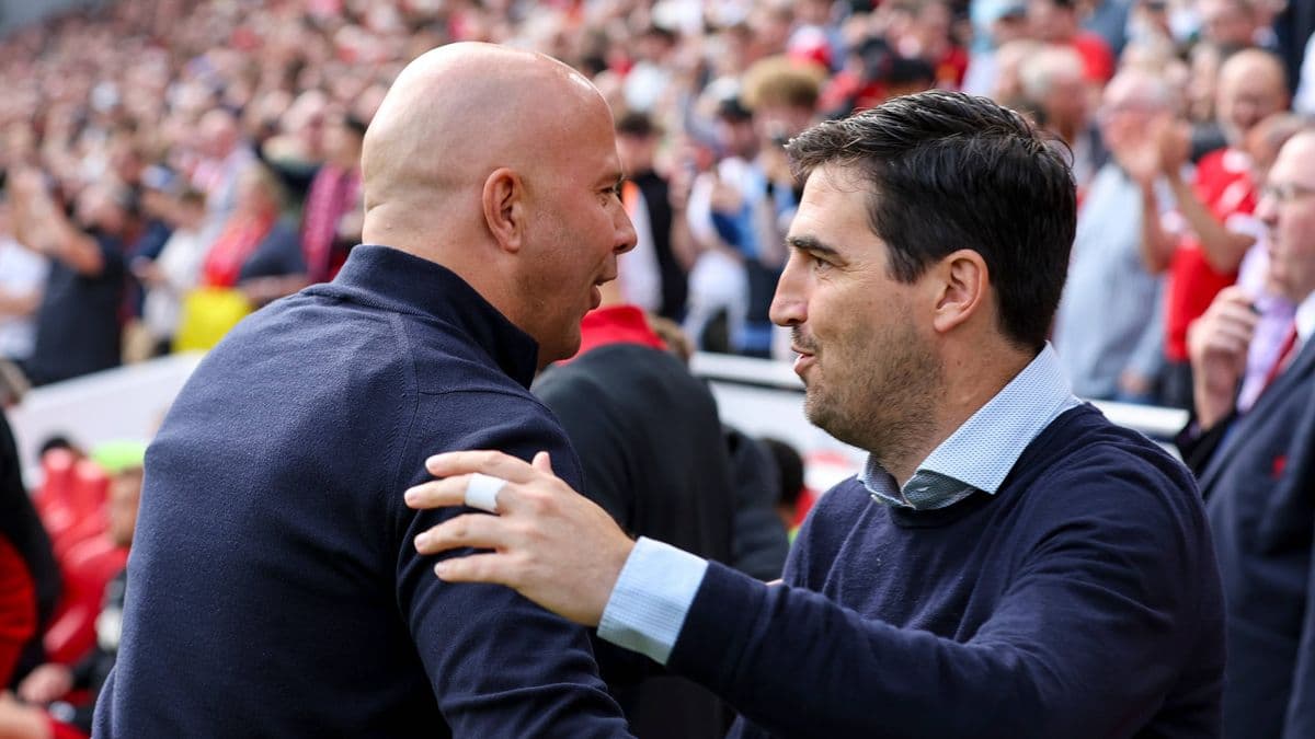 Two coaches greeting each other on the sidelines Two coaches greeting each other on the sidelines