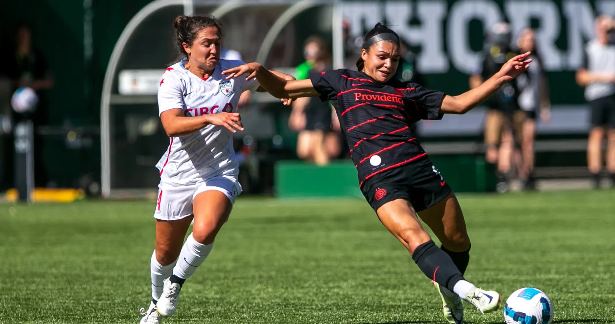 Player tackles opponent during NWSL match Player tackles opponent during NWSL match