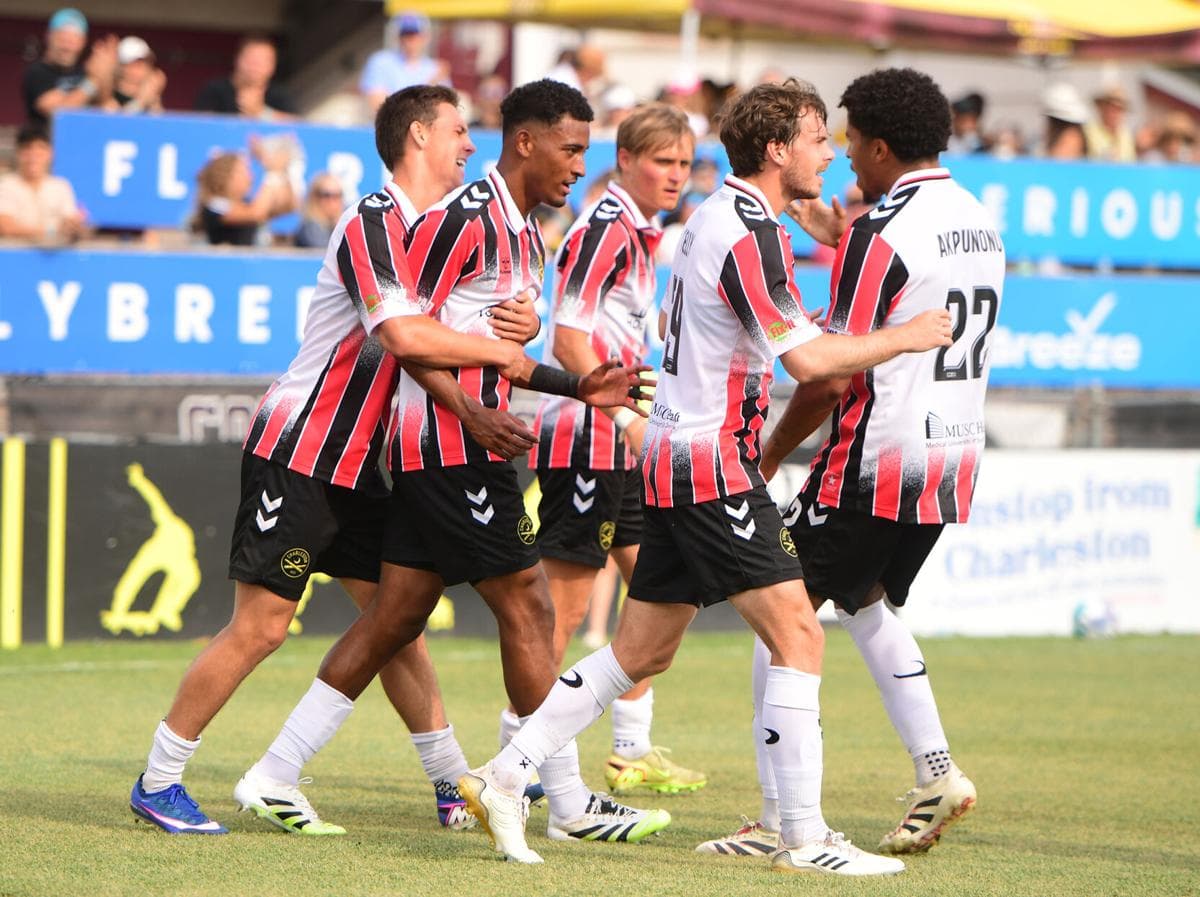 Players celebrating a goal during match Players celebrating a goal during match