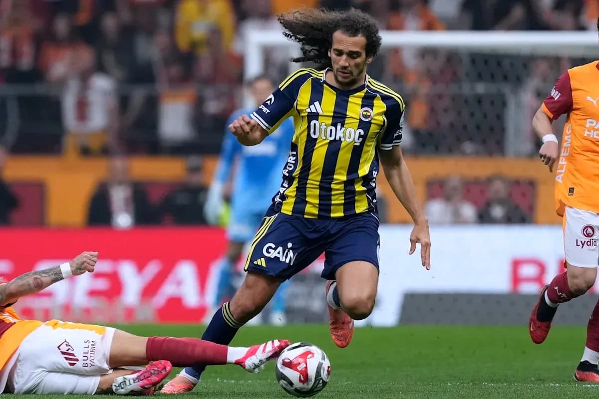 Fenerbahçe player dribbling past fallen opponent Fenerbahçe player dribbling past fallen opponent
