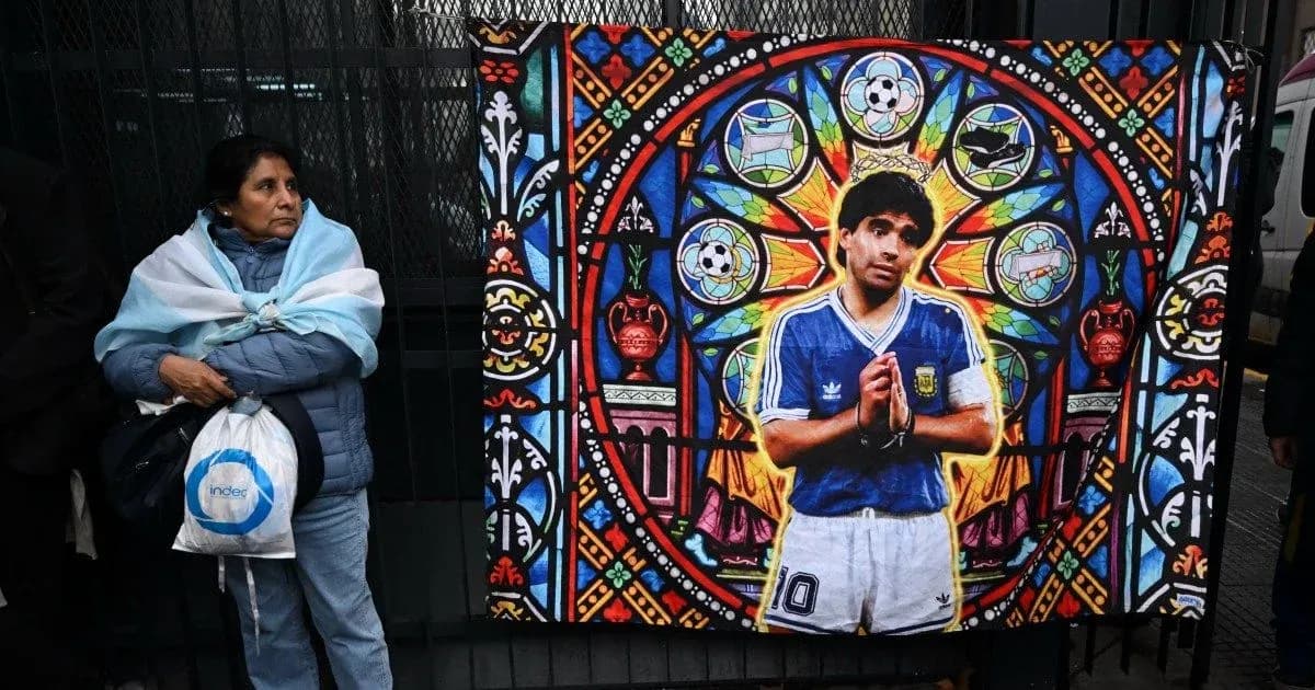 Woman standing next to mural of Diego Maradona Woman standing next to mural of Diego Maradona