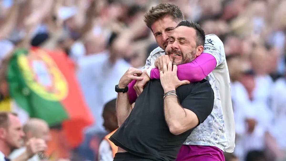 Two coaches celebrating in a crowded stadium Two coaches celebrating in a crowded stadium