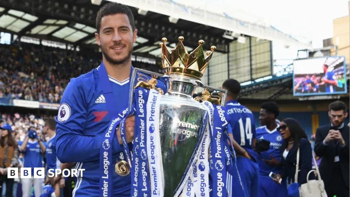 Player holding Premier League trophy at stadium Player holding Premier League trophy at stadium