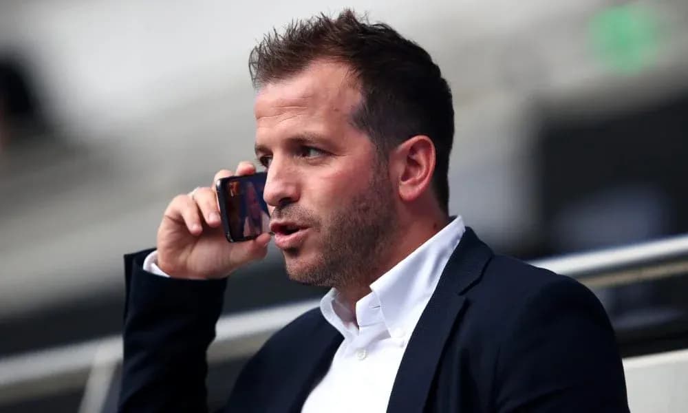 Person talking on a mobile phone in a stadium Person talking on a mobile phone in a stadium