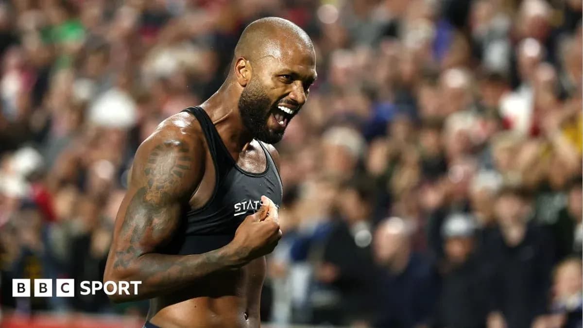 Athlete celebrating in front of cheering crowd Athlete celebrating in front of cheering crowd