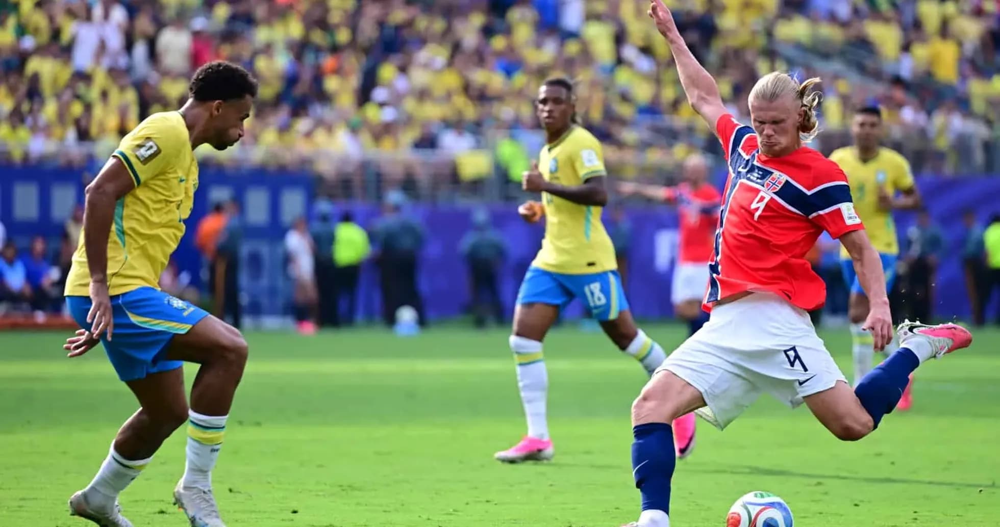 Brazil player challenges Norway player during match Brazil player challenges Norway player during match