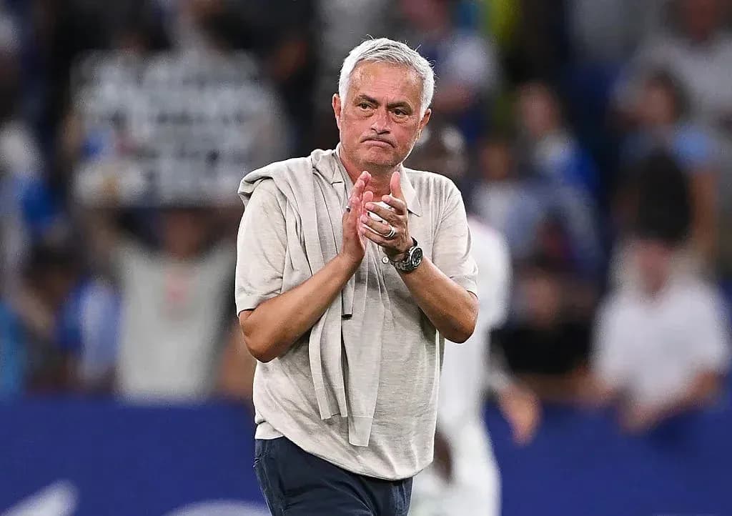 Coach applauding after a match on the pitch Coach applauding after a match on the pitch