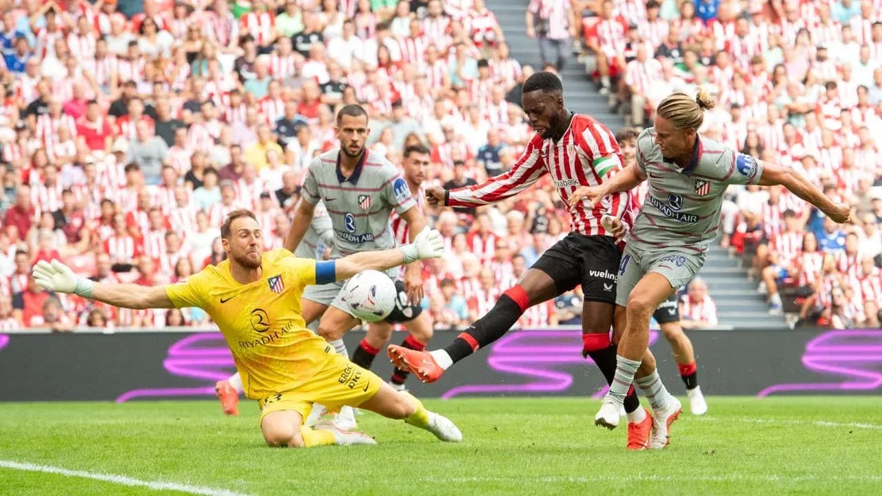 Athletic Club player shoots on goal against Atletico Athletic Club player shoots on goal against Atletico