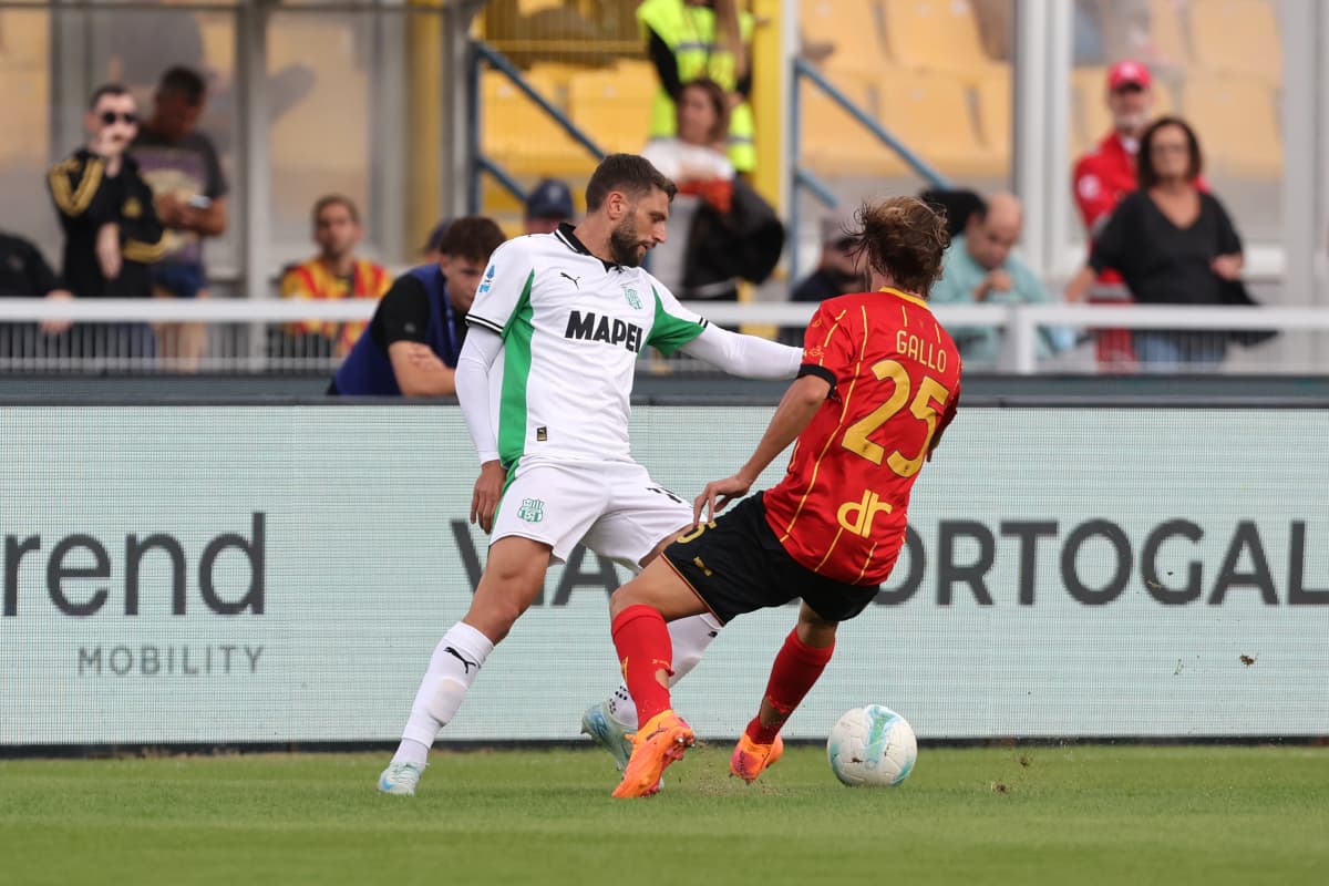Sassuolo player challenging Lecce player during match Sassuolo player challenging Lecce player during match