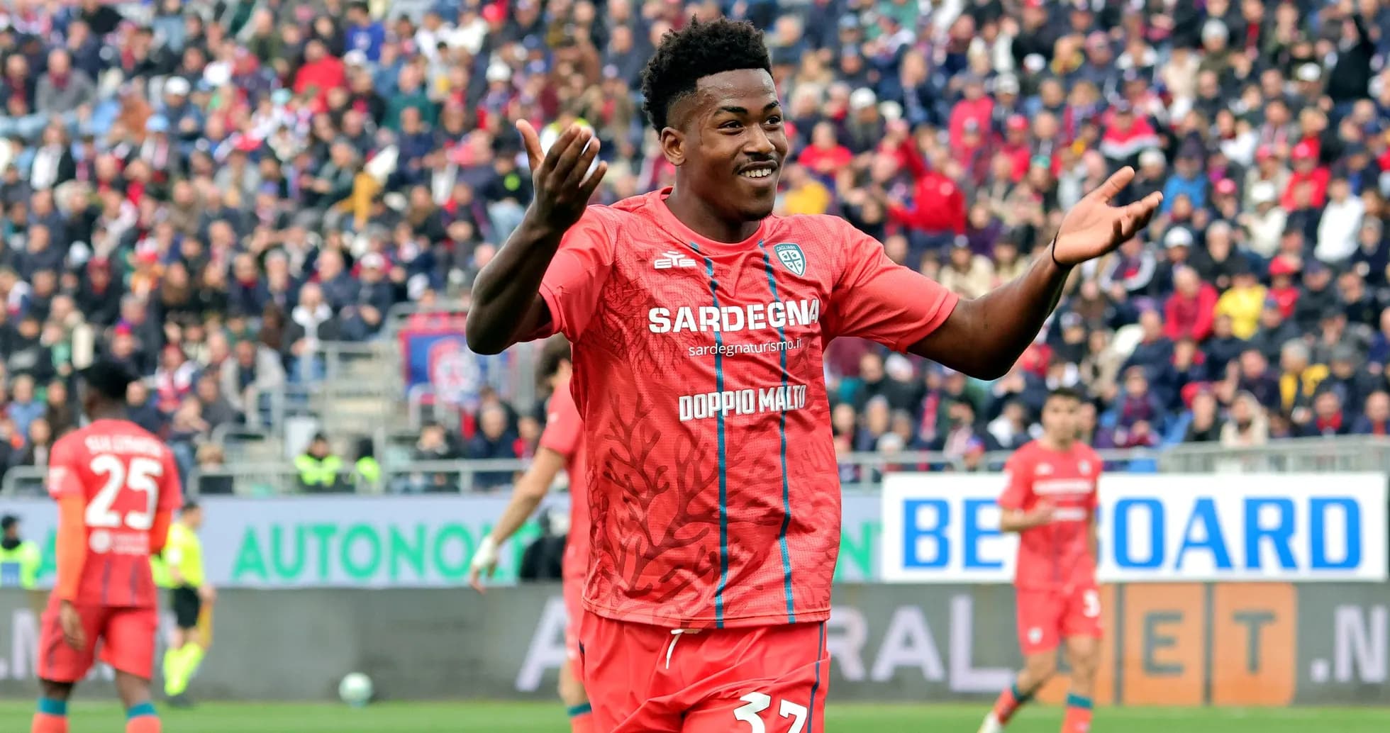 Player celebrating in red team uniform during match Player celebrating in red team uniform during match