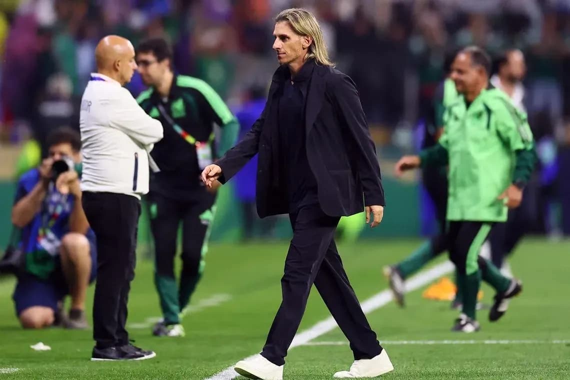Coach walking on field during match with staff Coach walking on field during match with staff