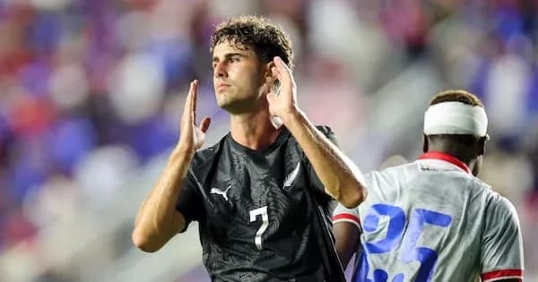 Player celebrating during a soccer match on field Player celebrating during a soccer match on field