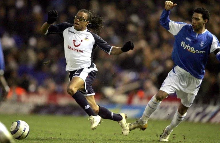 Player evading tackle during football match action Player evading tackle during football match action