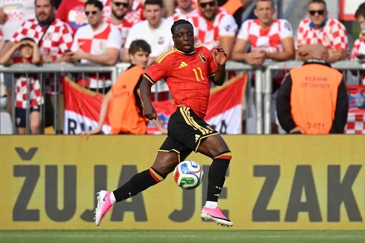 Belgian player running with ball during match Belgian player running with ball during match