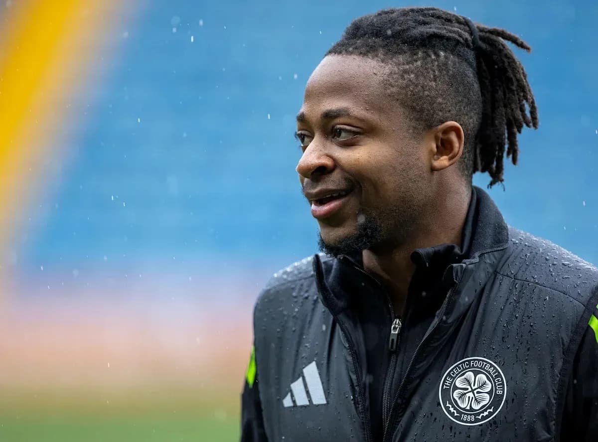 Player smiling in rain during training session Player smiling in rain during training session