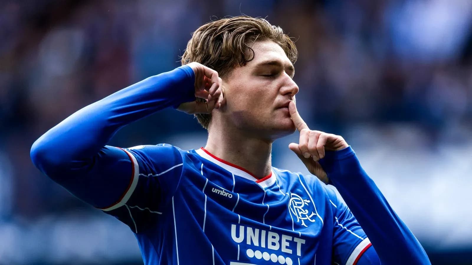 Player celebrating with finger to lips during match Player celebrating with finger to lips during match