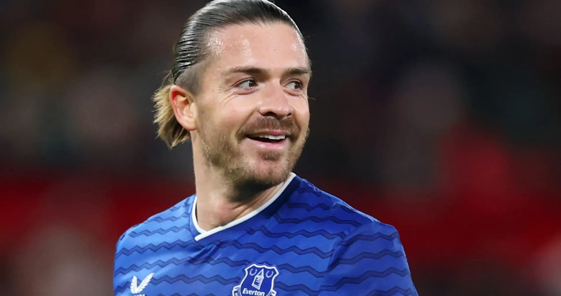 Football player in Everton jersey smiling on field Football player in Everton jersey smiling on field