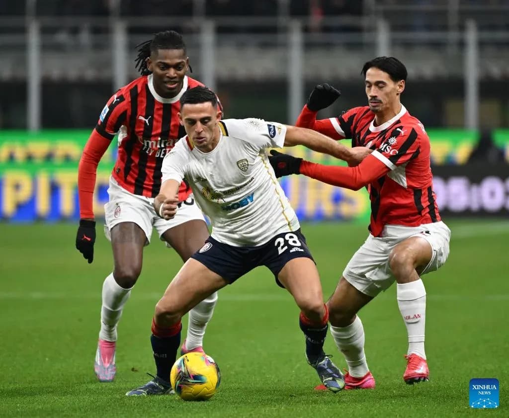 AC Milan players challenging Cagliari midfielder AC Milan players challenging Cagliari midfielder