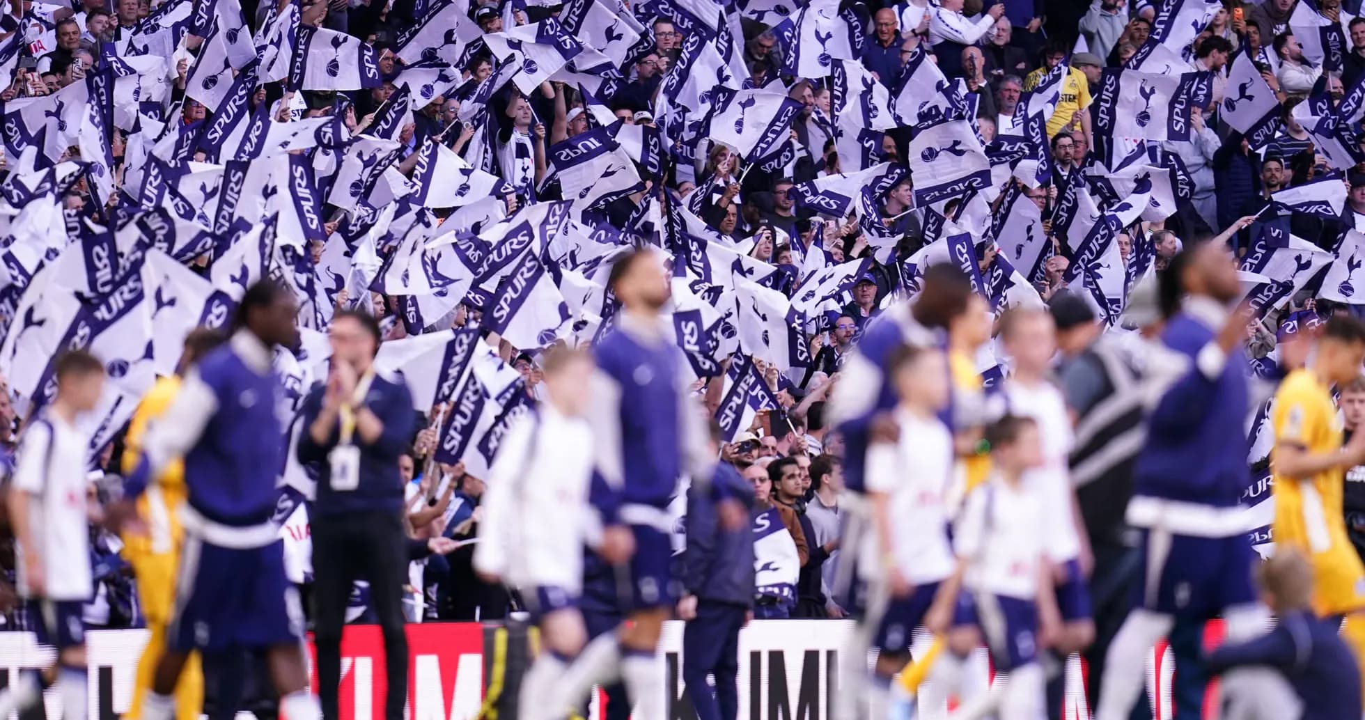 Fans waving flags during a Tottenham match Fans waving flags during a Tottenham match