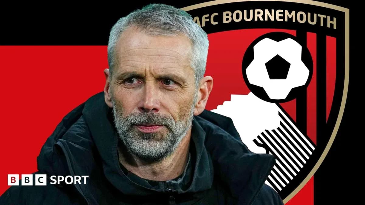 AFC Bournemouth manager with club logo in background AFC Bournemouth manager with club logo in background