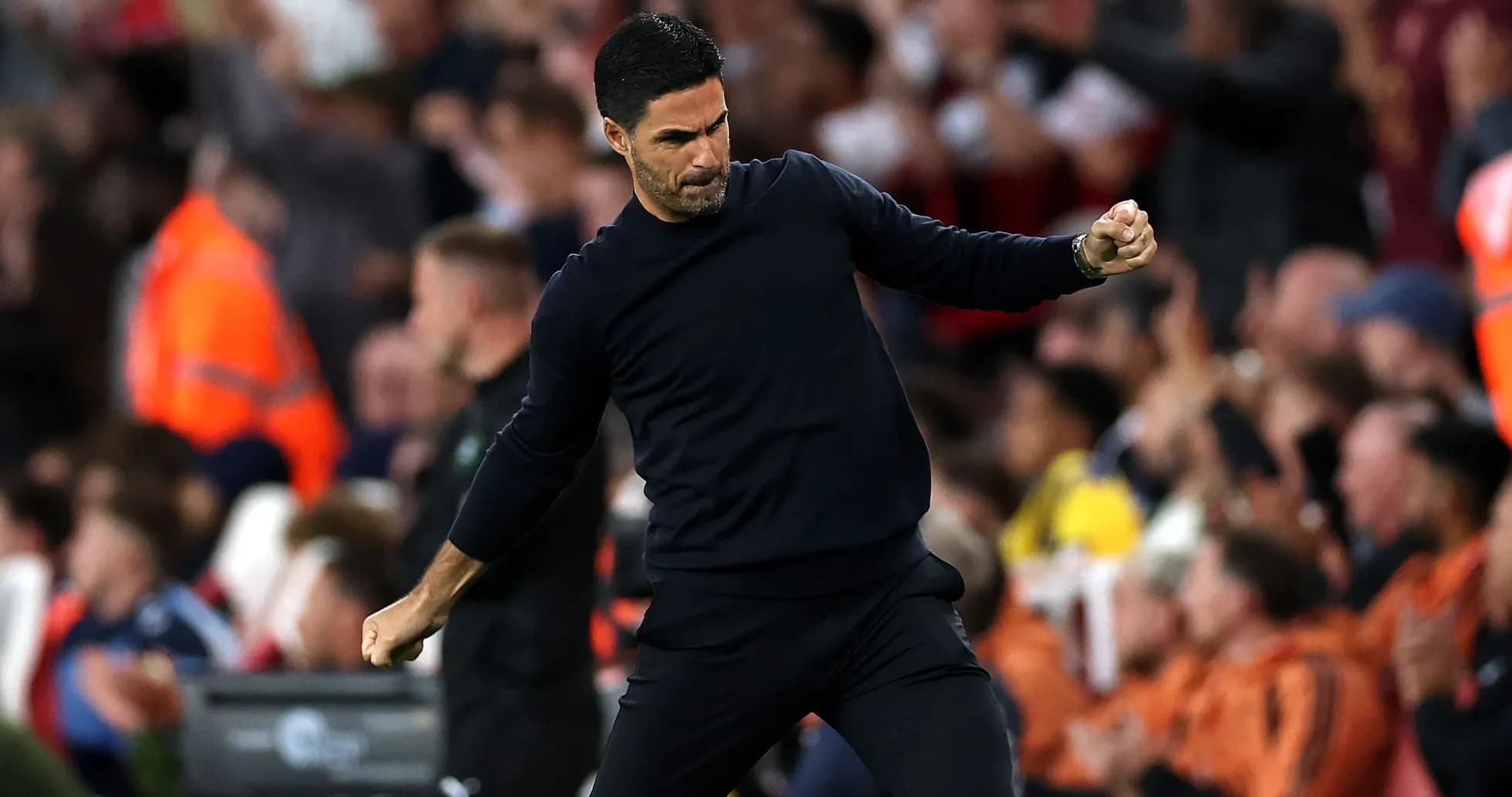 Coach celebrating during a match with fans cheering Coach celebrating during a match with fans cheering
