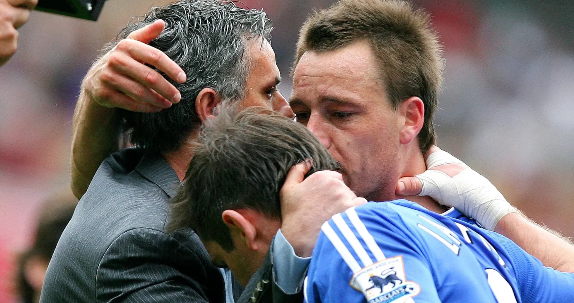 Players and coach embracing after match conclusion Players and coach embracing after match conclusion
