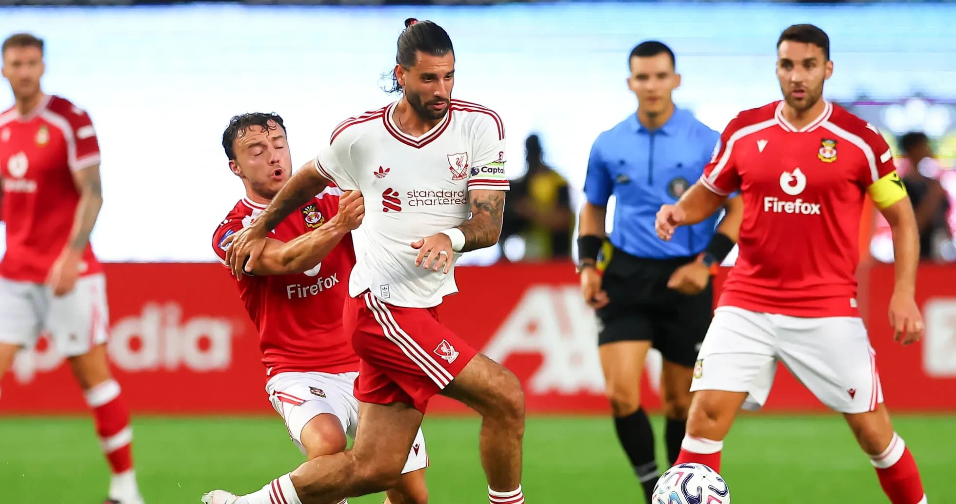 Player in white jersey evading opponent during match Player in white jersey evading opponent during match