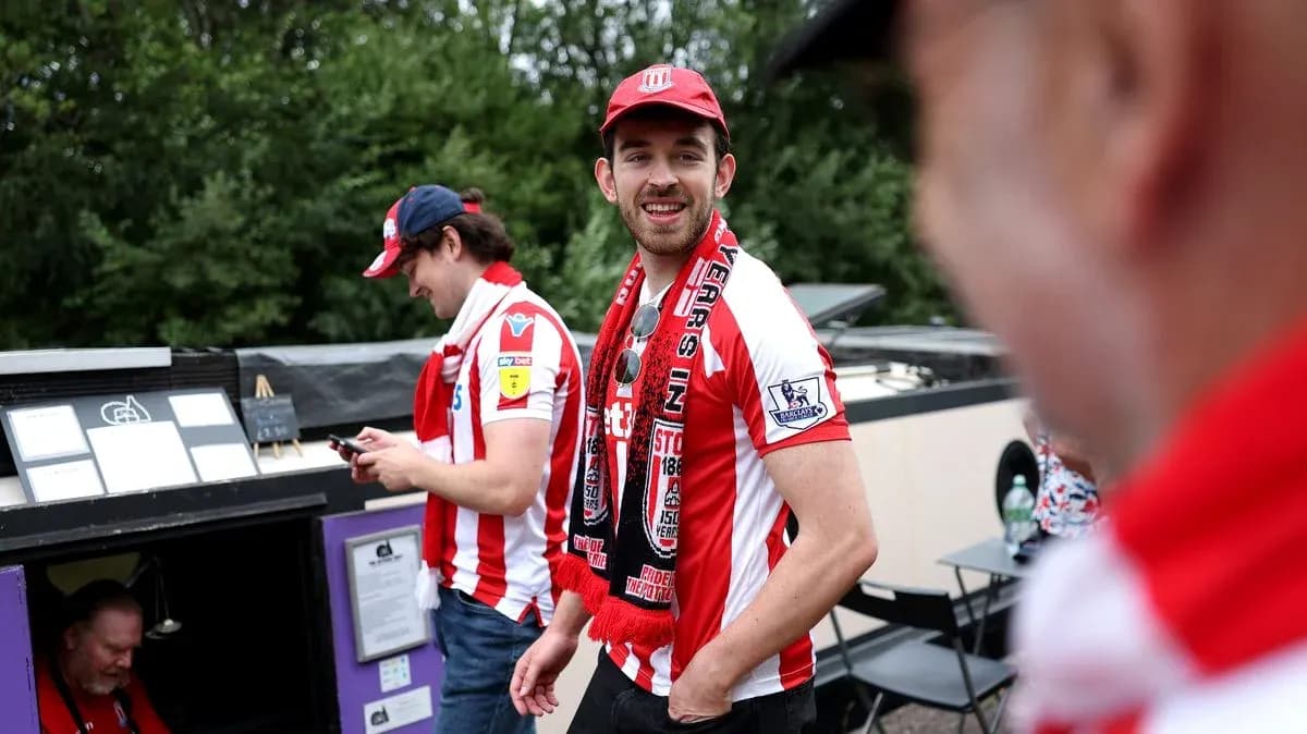 Fans wearing Stoke City shirts and scarves at event Fans wearing Stoke City shirts and scarves at event
