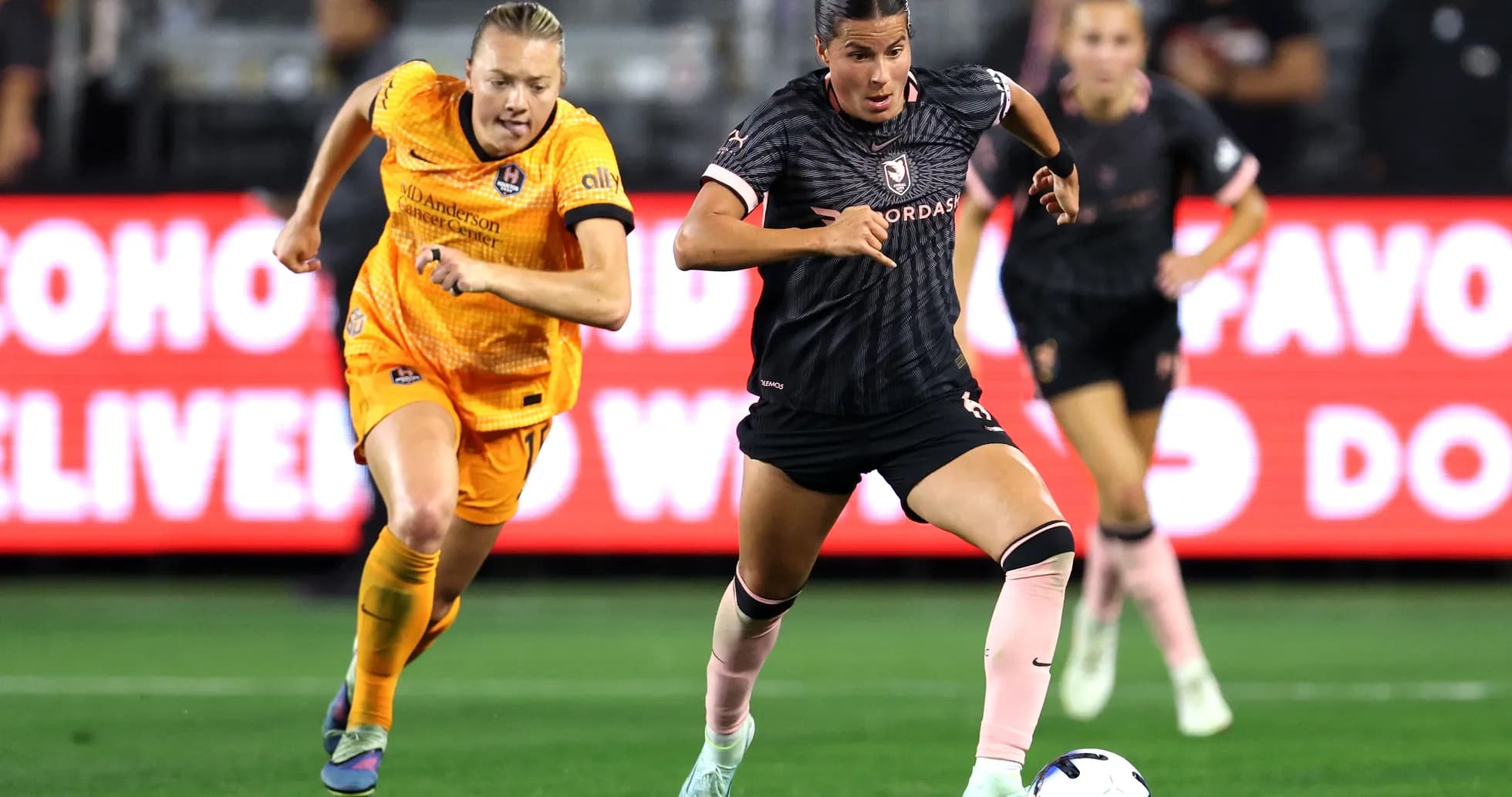 Houston Dash player dribbling past opponent Houston Dash player dribbling past opponent