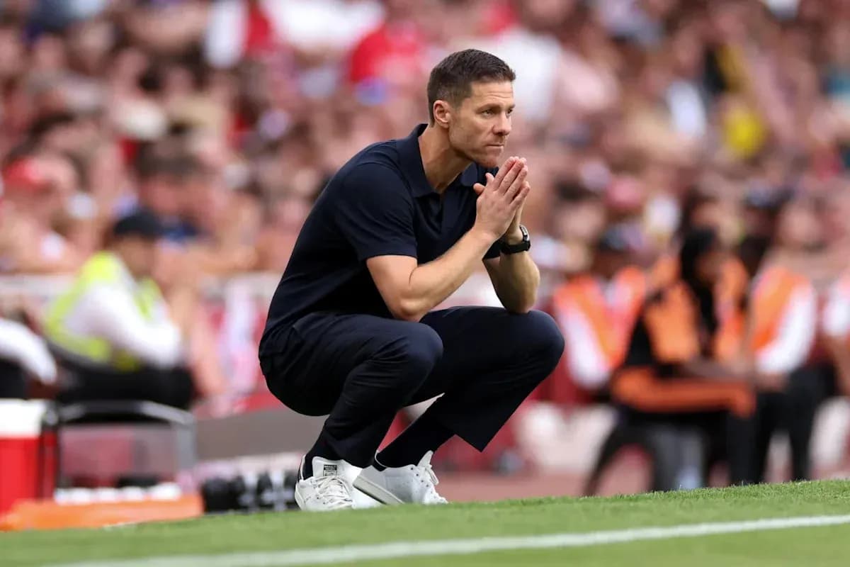 Coach observing the game while crouching on the sidelines Coach observing the game while crouching on the sidelines