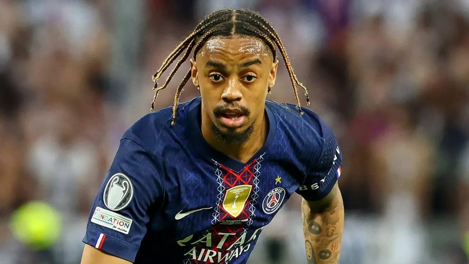 Player in PSG jersey running with the ball Player in PSG jersey running with the ball