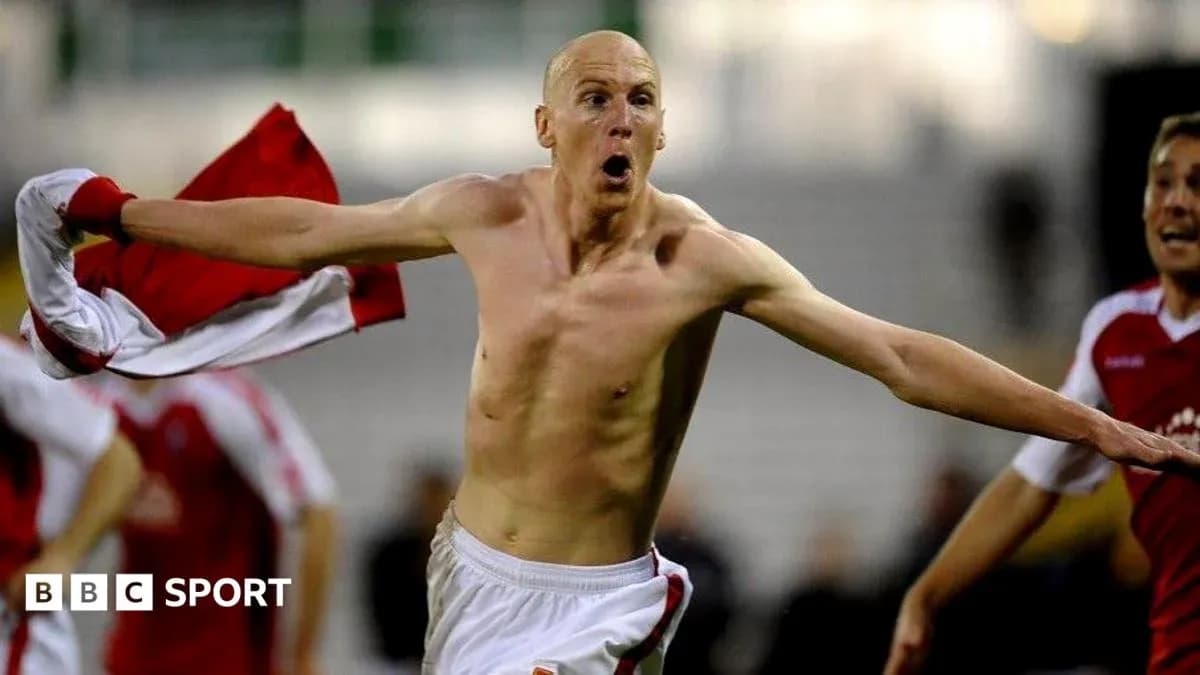 Player celebrating shirtless after scoring a goal Player celebrating shirtless after scoring a goal