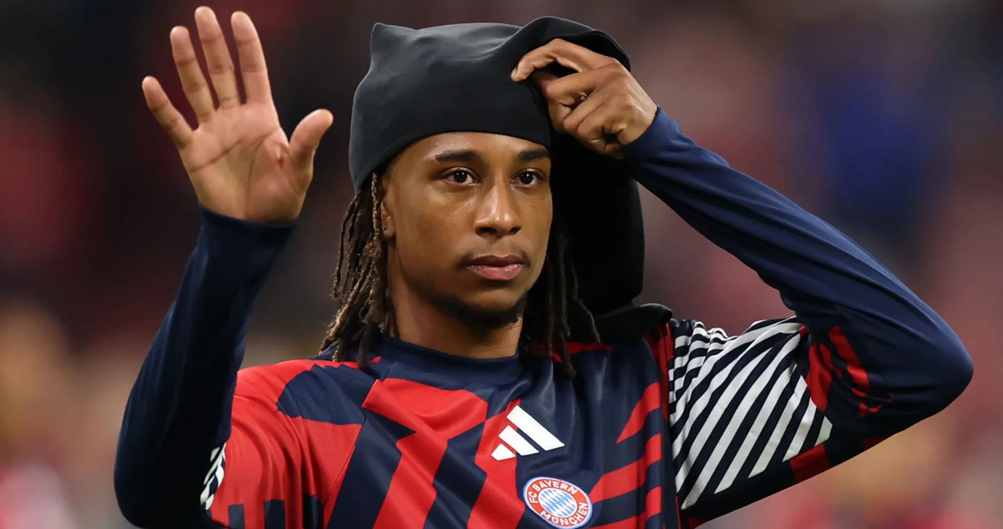 Player waving while adjusting his headwear Player waving while adjusting his headwear
