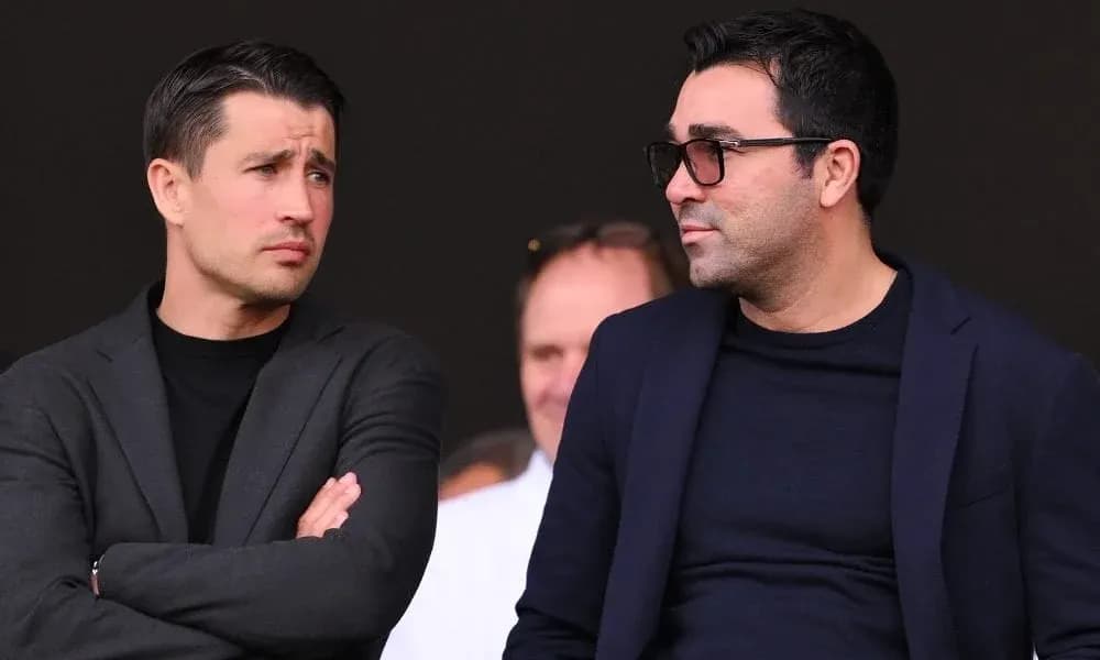 Two men talking in a stadium setting Two men talking in a stadium setting
