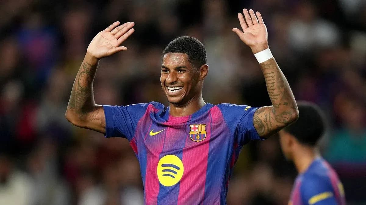 Player celebrating with raised hands on the pitch Player celebrating with raised hands on the pitch