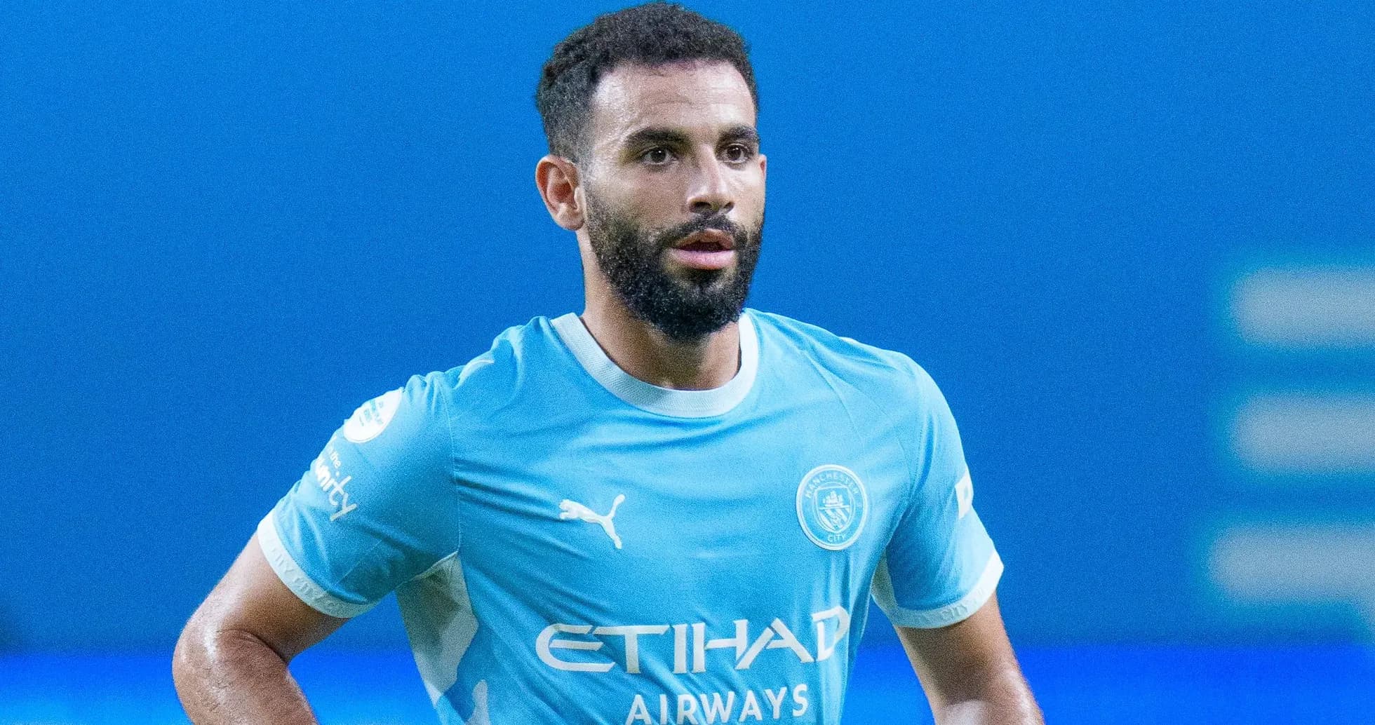 Player in Manchester City kit on the pitch Player in Manchester City kit on the pitch