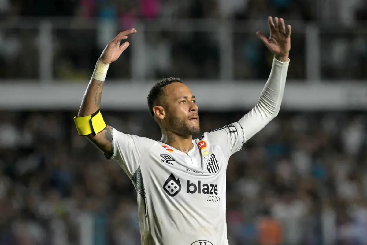 Player celebrating with arms raised during match Player celebrating with arms raised during match
