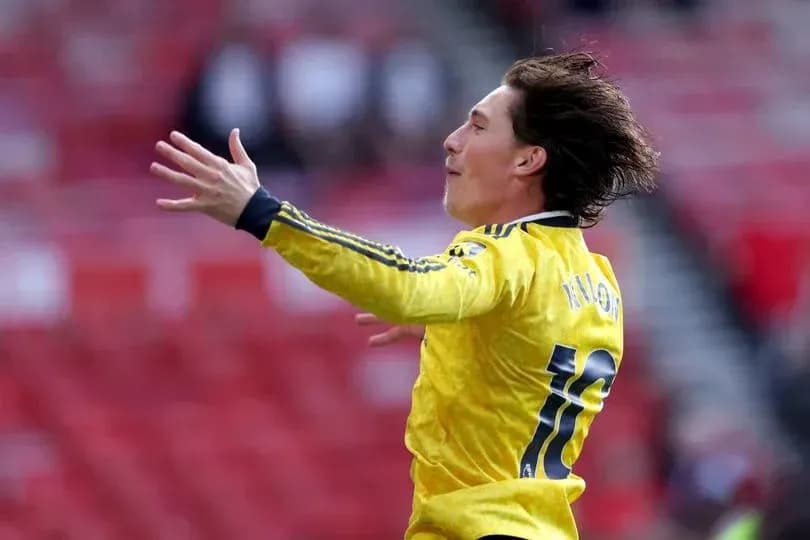 Player celebrating a goal in yellow jersey Player celebrating a goal in yellow jersey