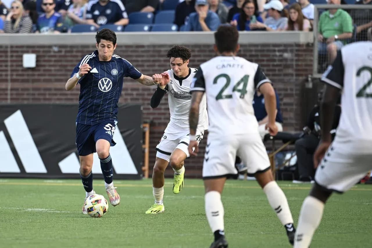 Player competing for the ball in MLS Next Pro match Player competing for the ball in MLS Next Pro match